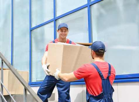 A large moving truck parked in front of an office building.