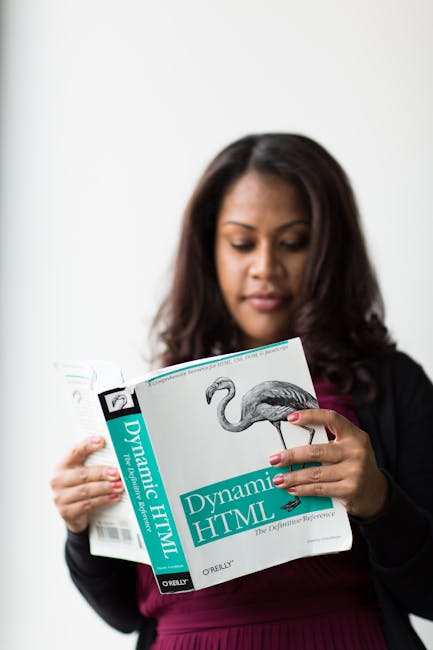 Close-up view of a computer screen displaying lines of HTML and CSS code with colorful syntax highlighting, including tags such as <h1>, <div>, and <img>, as well as image source paths and class attri